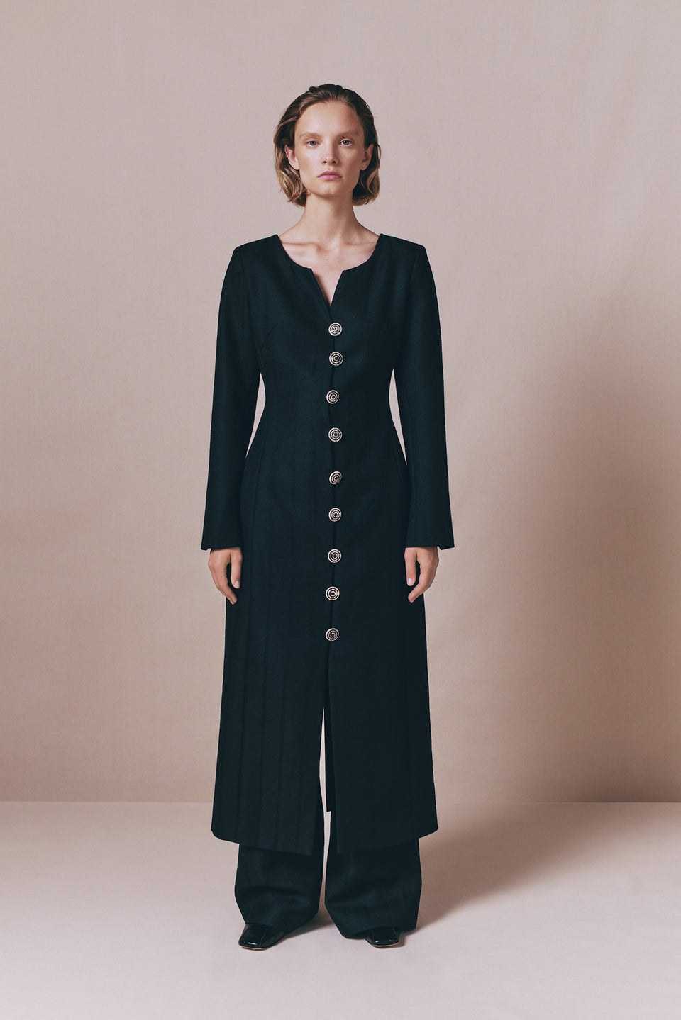 Black long-sleeve dress with refined button details